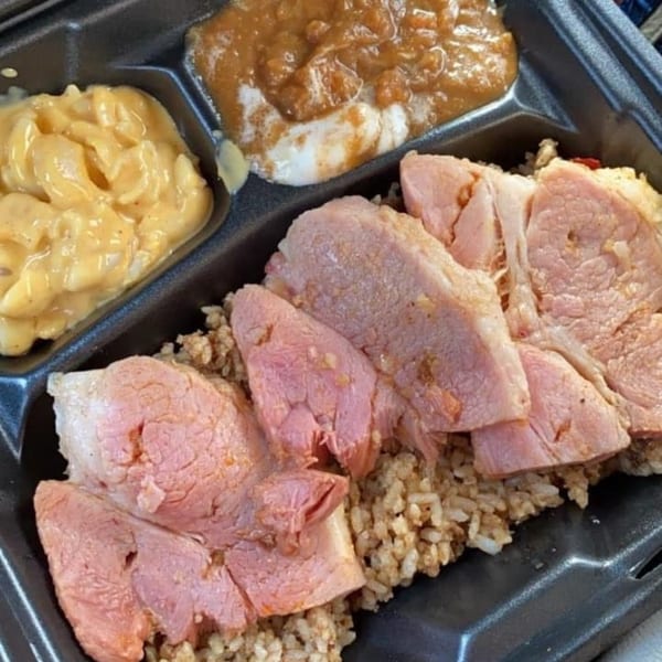 A soul food meal with sliced ham over rice, mac and cheese, and baked apples.